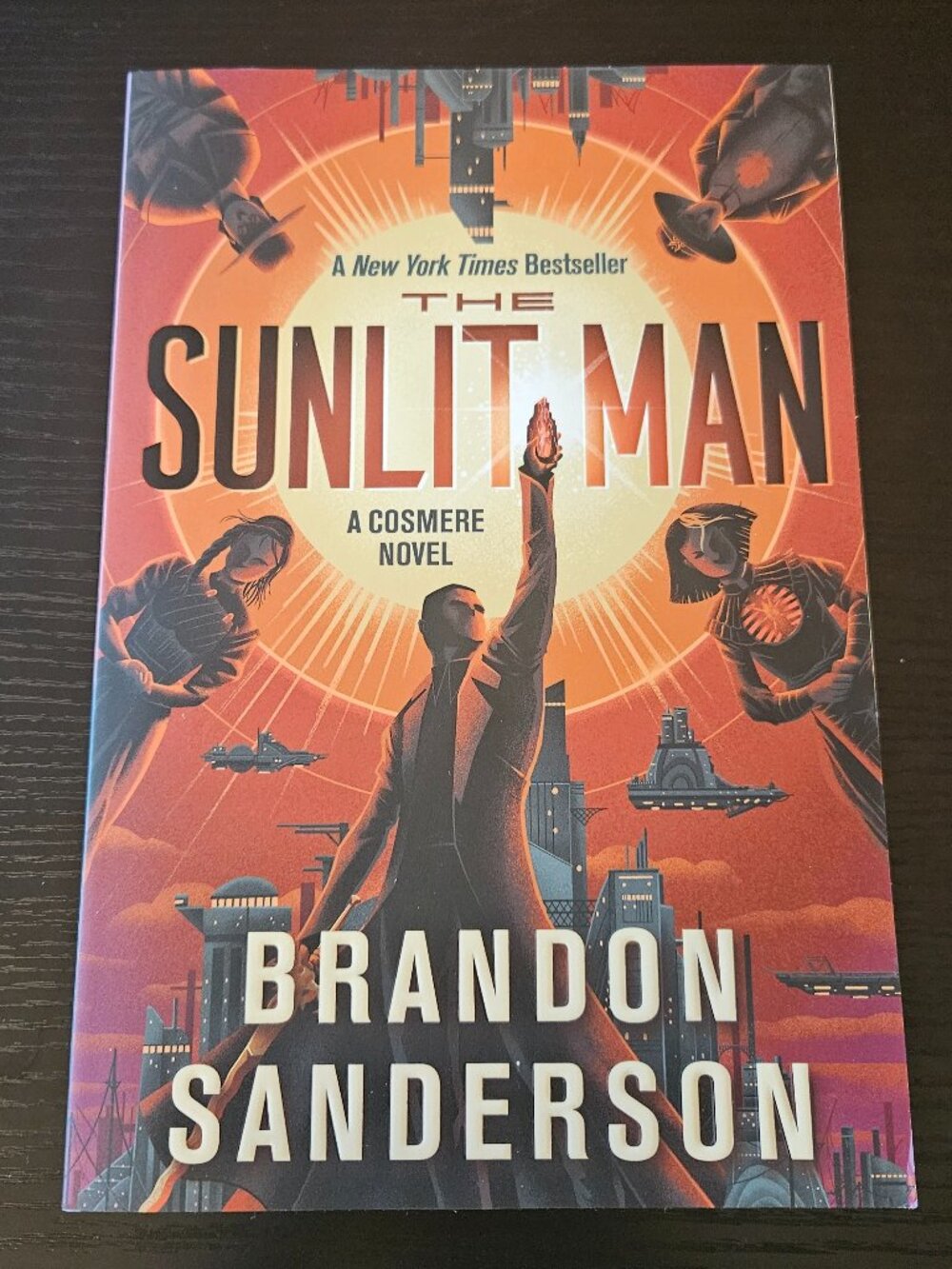 Paperback book the sunlit man by Brandon Sanderson